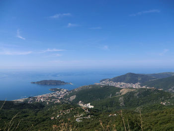 Scenic view of sea and mountains against sky