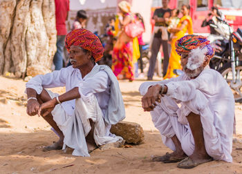 People sitting on sand