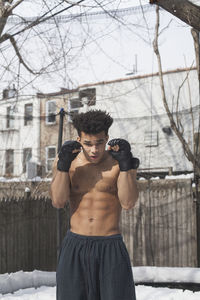 Young male boxer posing in the snow