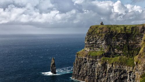 Scenic view of sea against cloudy sky