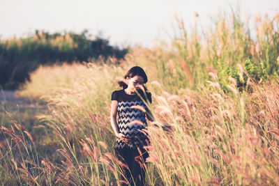 Pregnant woman standing on field