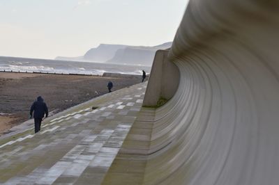 Rear view of woman on mountain against sky