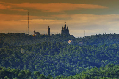 Distant view of sagrat cor at tibidabo during sunset