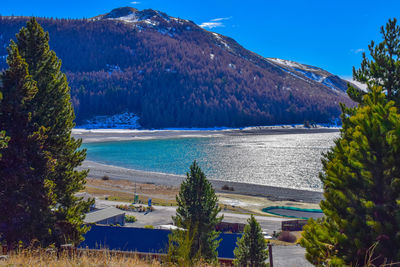 Scenic view of sea and mountains against sky