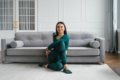 Yoga instructor., a young woman sitting in a stretching asana at home in the morning