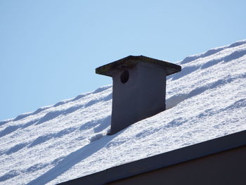 Low angle view of cross against clear blue sky