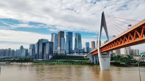 View of bridge over river against cloudy sky