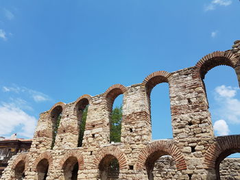 Low angle view of old ruin building against sky