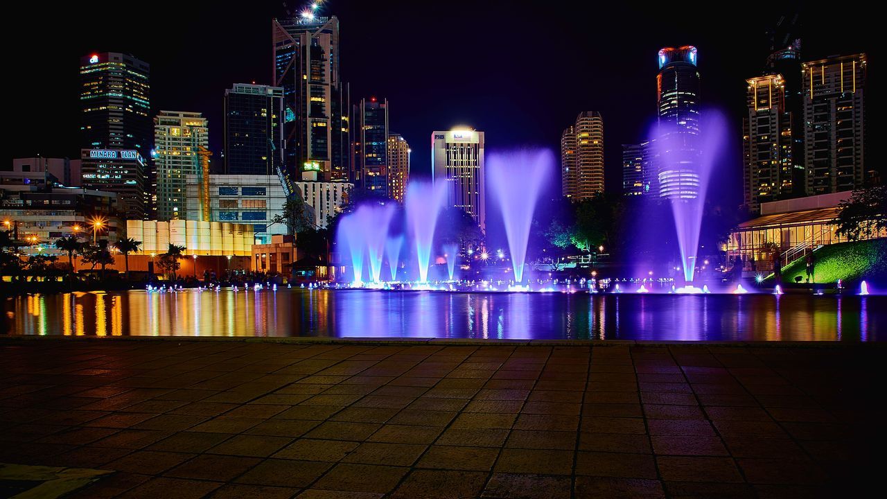 night, building exterior, illuminated, architecture, built structure, city, skyscraper, cityscape, modern, tall - high, tower, office building, capital cities, financial district, famous place, travel destinations, urban skyline, fountain, long exposure, city life