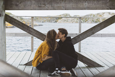 Women kissing on jetty