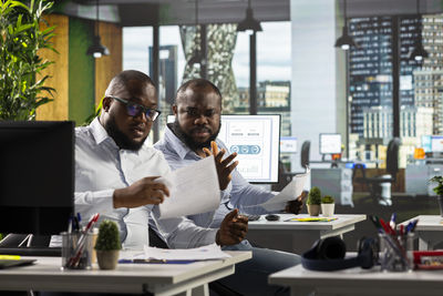 Young woman using laptop at cafe