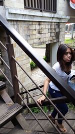 Woman sitting on staircase