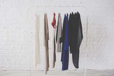 Clothes hanging against white wall