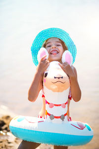 Portrait of cute girl wearing hat on beach