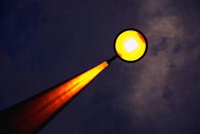 Low angle view of illuminated street light against sky