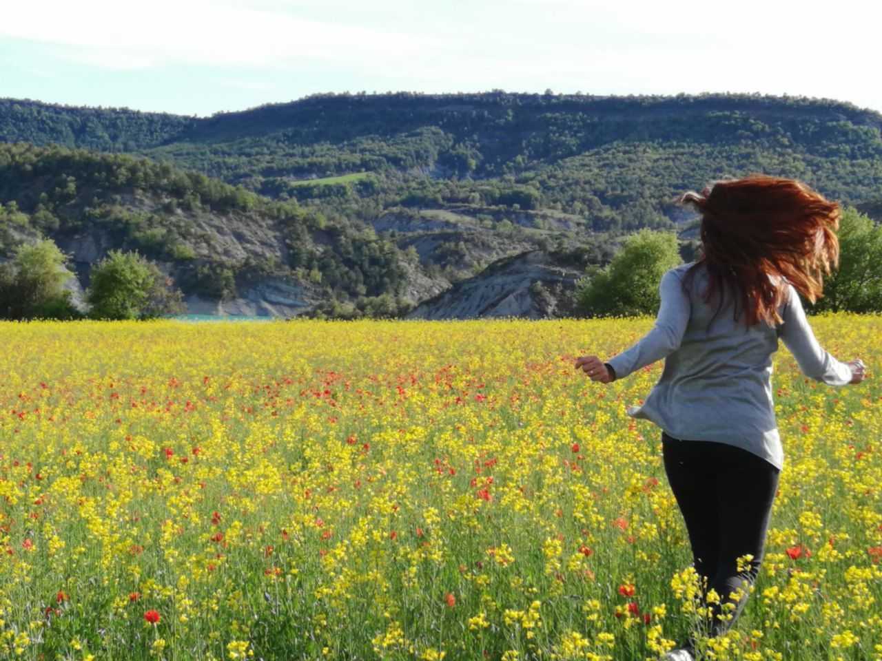 plant, one person, field, land, leisure activity, beauty in nature, lifestyles, real people, nature, environment, growth, casual clothing, three quarter length, adult, hairstyle, standing, landscape, young adult, day, flower, hair, outdoors, freedom