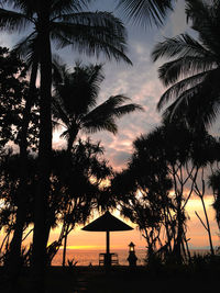 Silhouette palm trees against sky during sunset
