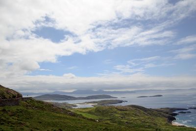 Scenic view of sea and mountains against sky