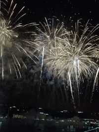 Low angle view of firework display at night