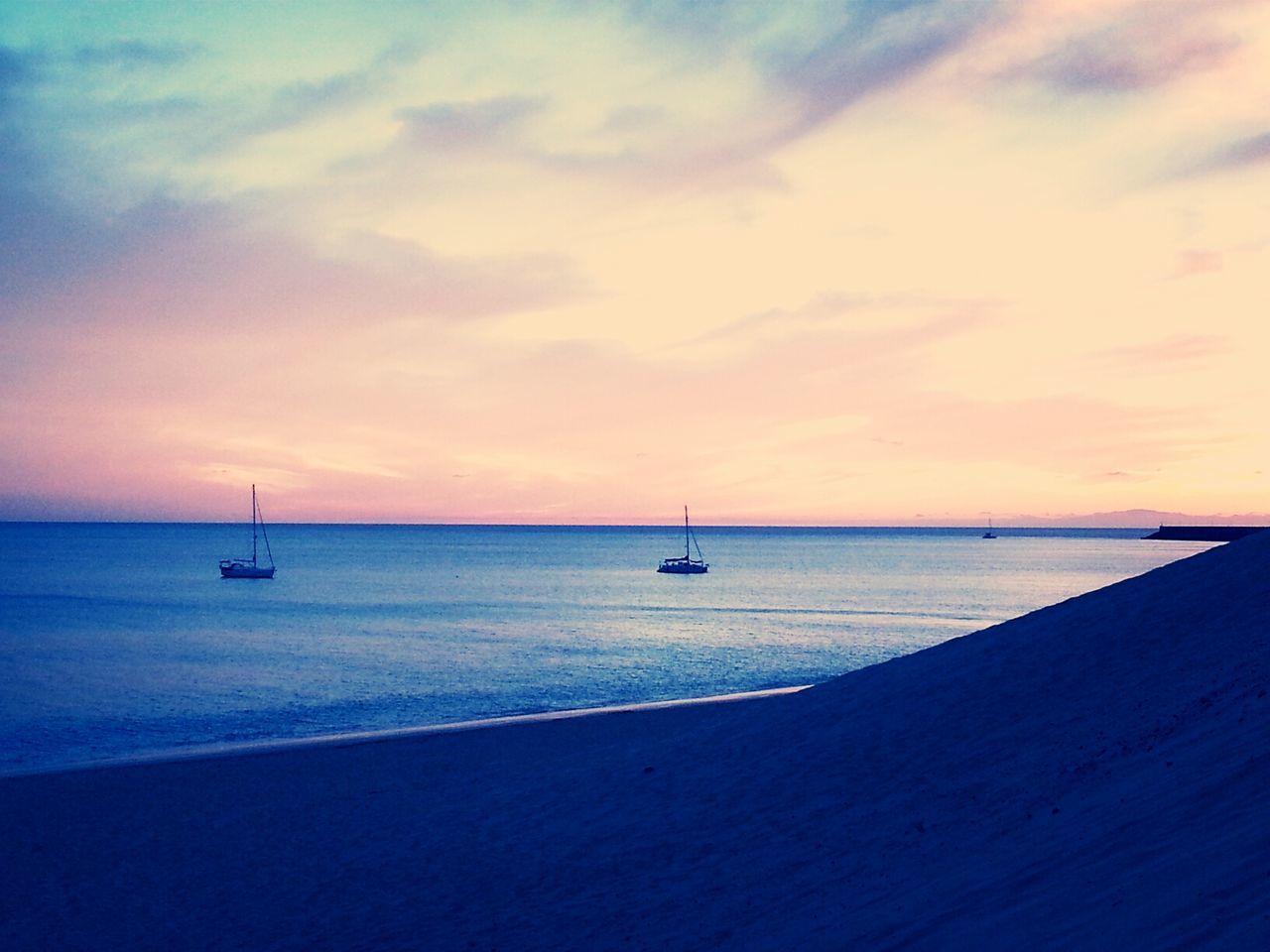 sea, horizon over water, water, nautical vessel, transportation, boat, mode of transport, sunset, sky, scenics, beauty in nature, tranquil scene, tranquility, nature, beach, cloud - sky, idyllic, orange color, shore, travel