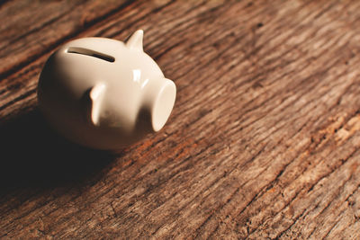 High angle view of piggy bank on wooden table