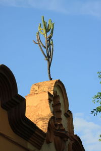 Low angle view of statue against blue sky