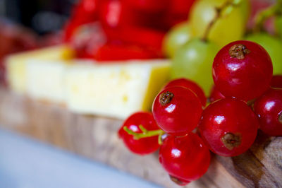 Close-up of berries, grapes and cheese on table