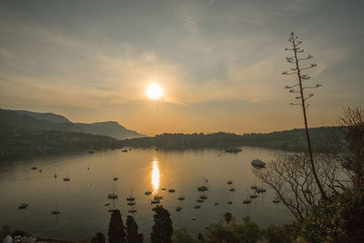 Scenic view of lake against sky during sunset