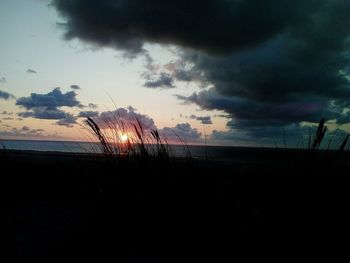 Silhouette landscape against sky during sunset