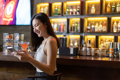 Young woman drinking glasses on table