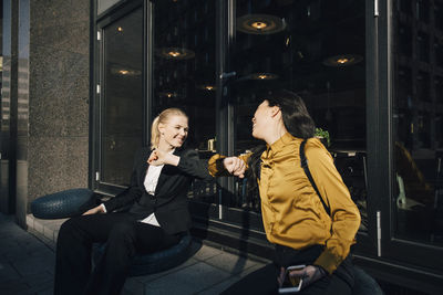 Women greeting using elbows