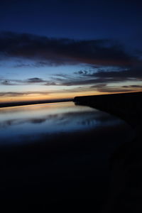 Scenic view of lake against sky at sunset