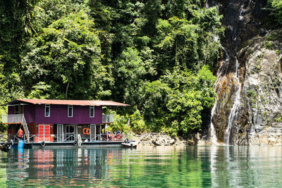 Built structure in lake against trees in forest