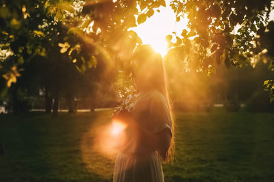 Rear view of woman standing on street at night