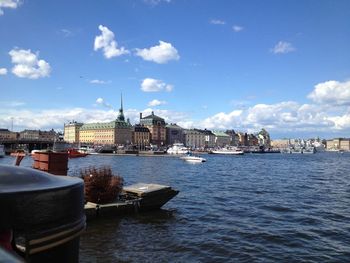 Boats in harbor with buildings in background