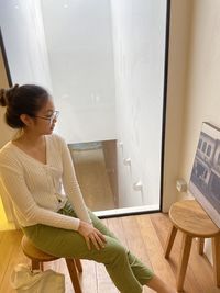 Woman sitting on chair at home