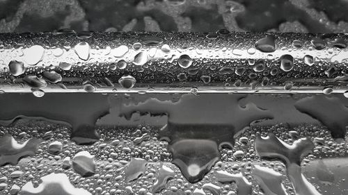 Close-up of water drops on metal