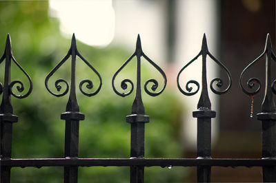 Close-up of metal fence against building