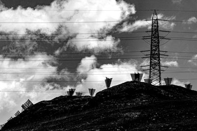 Low angle view of avalanche barriers and trellis against sky