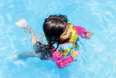 High angle view of girl swimming in pool