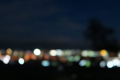 Defocused image of illuminated city at night