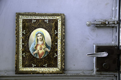 Picture frame of virgin mary against door