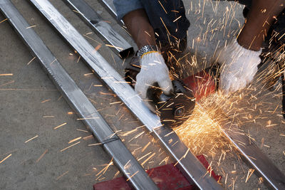 High angle view of man working on metal