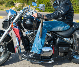 Low section of man sitting on motorcycle