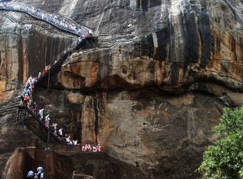 High angle view of people on bridge against rocks