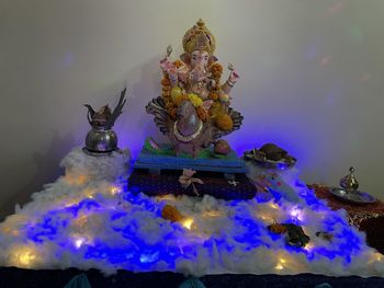 Statue against illuminated temple