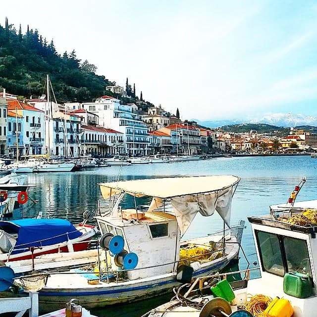 BOATS MOORED AT HARBOR AGAINST SKY