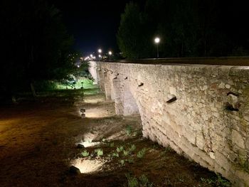 Stone wall in park at night
