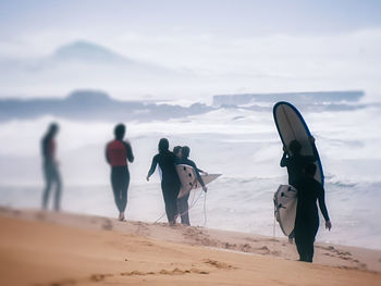 People on beach against sky