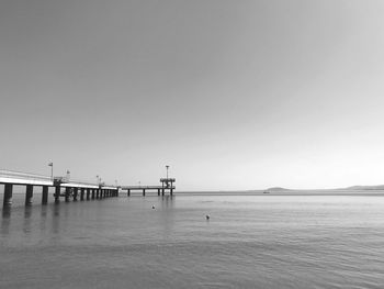 Pier over sea against clear sky